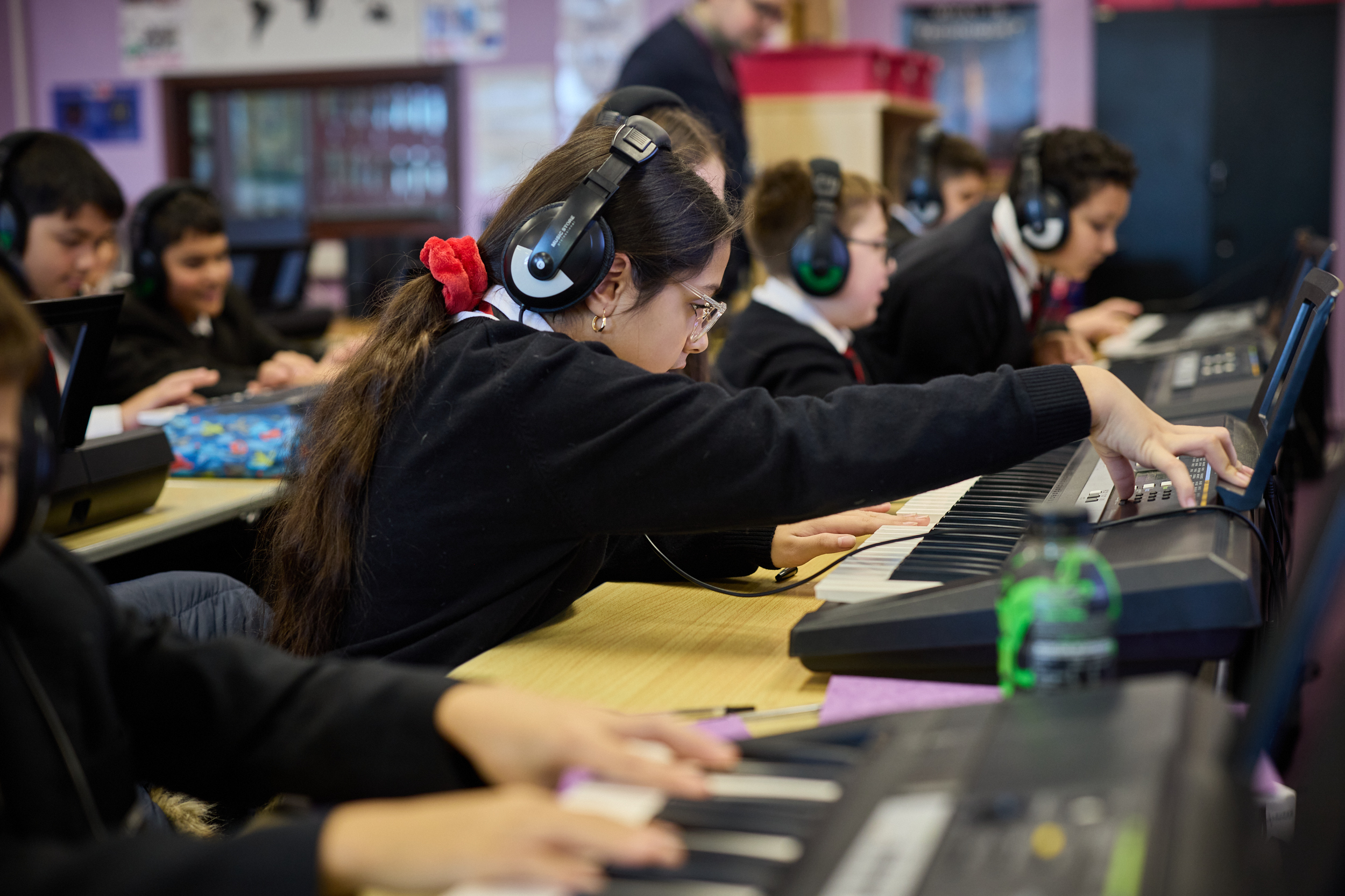 Children at Lyng Hall playing the piano