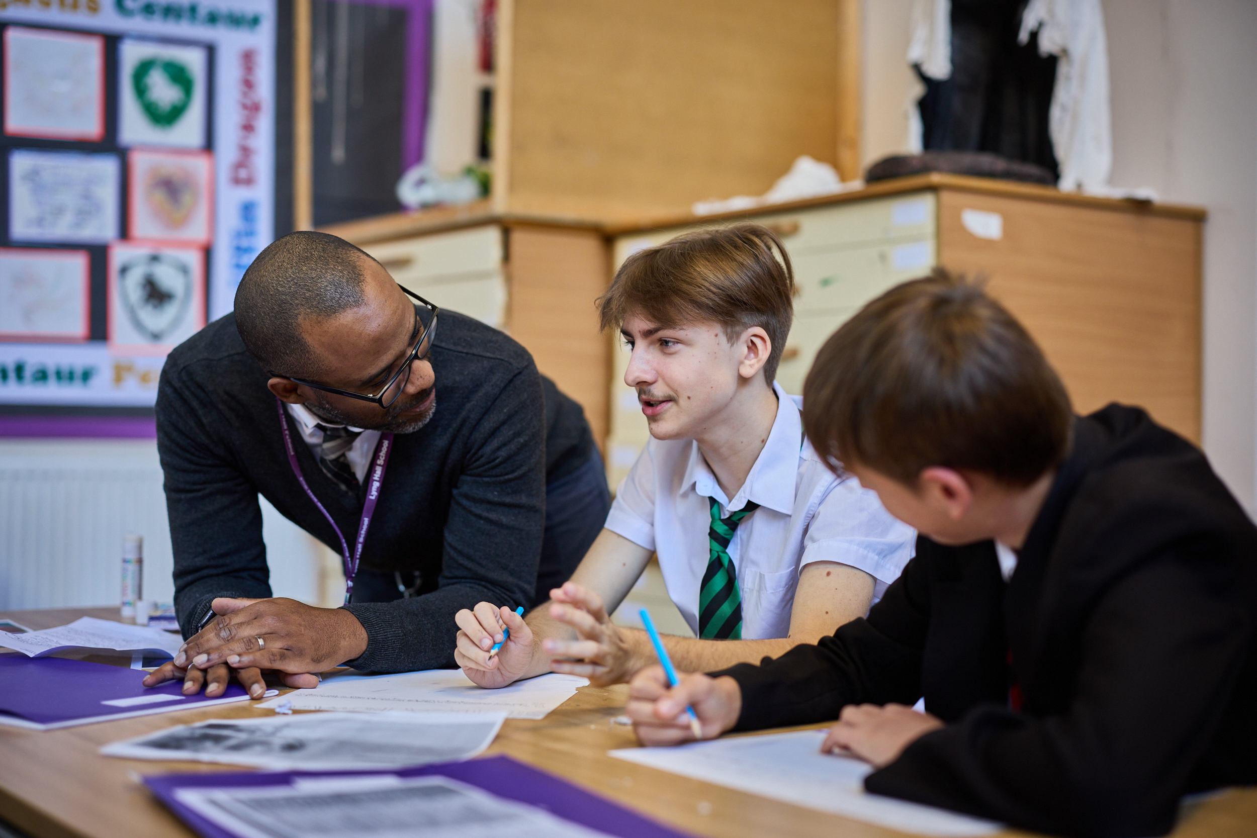 teacher supporting pupils